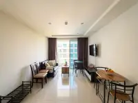 1 Bedroom Condo for Sale at Novana Residence open living area with seating, TV and city view balcony