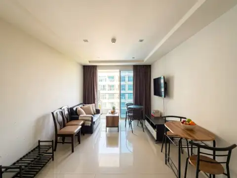 1 Bedroom Condo for Sale at Novana Residence open living area with seating, TV and city view balcony