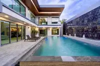 6 Bedroom House for Sale at M Mountain Village private pool with fountain wall, glass balustrade balcony, and stone tile surround at dusk