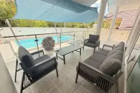 3 Bedroom House for Sale at Royal Prestige covered poolside terrace with dark outdoor sofa set and shade sail