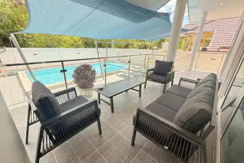 3 Bedroom House for Sale at Royal Prestige covered poolside terrace with dark outdoor sofa set and shade sail