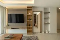 1 Bedroom Condo for Sale at Zensiri Estates and Residences wooden TV feature wall with built-in shelving unit and LED cove ceiling lighting