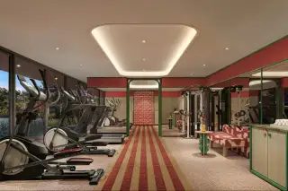D Condo Vite fully equipped fitness center with cardio machines, weight equipment, mirrored walls, and garden views