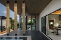 3 Bedroom House for Sale at Baan Pattaya 7 (Ascent) outdoor patio with pool view, leading to an indoor living area and kitchen.
