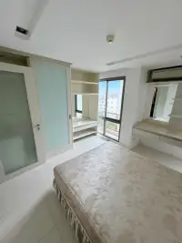 2 Bedroom Condo for Sale at The Urban Pattaya bedroom with built-in wardrobe, vanity desk and balcony window