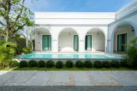 4 Bedroom House for Sale in Nong Prue private pool with arched white facade and manicured garden landscaping