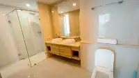 2 Bedroom Condo for Sale at The Riviera Jomtien bathroom with double vanity sinks and glass shower
