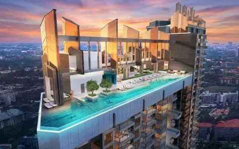 Copacabana Coral Reef rooftop infinity pool with sun loungers and a modern high-rise building exterior.