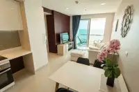 1 Bedroom Condo for Sale & Rent at Palm Wongamat open-plan living and dining area with sea view