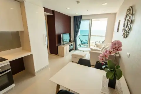 1 Bedroom Condo for Sale & Rent at Palm Wongamat open-plan living and dining area with sea view