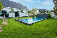 3 Bedroom House for Sale at Coco Ville 2 Pong - Bang Lamung backyard private pool with green lawn and sliding glass doors to house