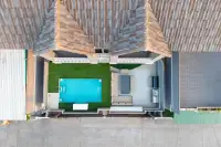 10 Bedroom House for Sale in Bang Lamung top-down drone view of tiled roof, private pool, green lawn, and covered lounge area