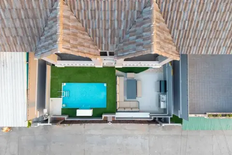 10 Bedroom House for Sale in Bang Lamung top-down drone view of tiled roof, private pool, green lawn, and covered lounge area