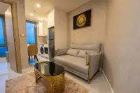 1 Bedroom Condo for Rent at Copacabana Beach Jomtien living area with gray sofa and open kitchen