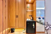 Studio Condo for Sale at Wyndham Jomtien Pattaya: contemporary living space with TV, desk, chair, and abstract art on the wall.