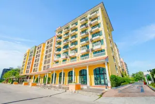 Venetian Signature Condo Resort yellow condo building facade with balconies and ground-floor arched windows