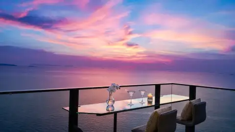 3 Bedroom Condo for Sale at Northpoint balcony table with cocktail glasses overlooking ocean sunset