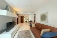 2 Bedroom Condo for Sale & Rent at The Sanctuary Wongamat spacious living room with TV unit, leather sofa and open kitchen