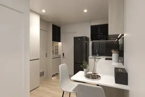 1 Bedroom Condo for Sale at The Indeed Condo Pattaya compact kitchen and dining area with wood cabinetry, black fridge, and entryway
