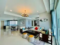 3 Bedroom Condo for Sale at Reflection Jomtien Beach spacious living and dining area with elegant wood furnishings