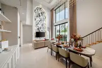 4 Bedroom House for Sale at Chieftain open-plan dining area with marble feature wall, arched TV niche, and staircase
