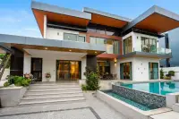 4 Bedroom House for Sale & Rent at M Mountain Village bedroom with blue bedding and black glass wardrobe
