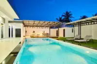 3 Bedroom House for Sale in Nong Prue illuminated private pool at night with marble surround, sunloungers and covered outdoor lounge
