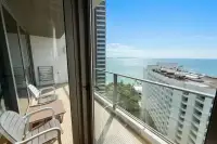 1 Bedroom Condo for Rent at Northpoint private balcony with seating and glass railing overlooking the sea