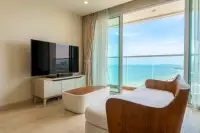 1 Bedroom Condo for Sale at Cetus Beachfront bright living room with flat-screen TV and panoramic sea view balcony