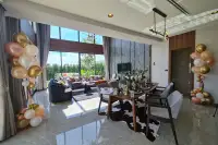 4 Bedroom House for Sale at Highbury Hill Pool Villas Pattaya open-plan dining and living area with marble floors and garden views