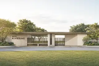 Patta Riverine grand entrance gate with modern architectural design, slatted facade, and manicured lawn