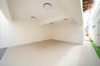4 Bedroom House for Sale at The Sunshine House spacious empty covered car park with white walls, smooth floor and ceiling spotlights