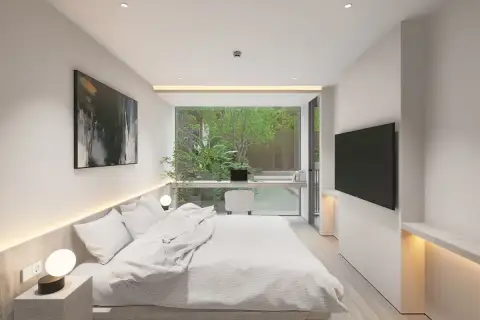 1 Bedroom Condo for Sale at Celine Wongamat minimalist bedroom with LED cove lighting, desk workspace, and tropical garden view