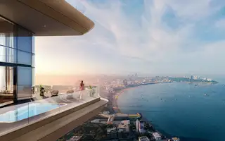 Once Wong Amat high-rise balcony with private pool, a woman, and panoramic Pattaya city and ocean views.