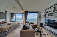 1 Bedroom Condo for Sale at Andromeda Condominium spacious studio layout with bed, sectional sofa, TV unit, and sea view