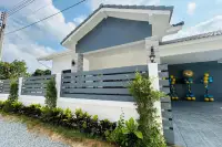 3 Bedroom House for Sale in Nong Prue front exterior with modern fence, landscaping, and driveway entrance.