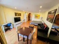 1 Bedroom Condo for Sale at View Talay 2 open-plan living room with sofa, dining table, desk and bed area