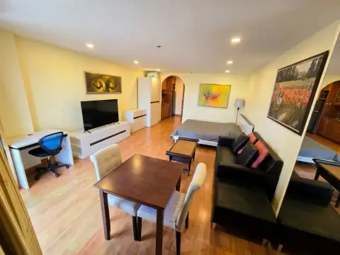 1 Bedroom Condo for Sale at View Talay 2 open-plan living room with sofa, dining table, desk and bed area
