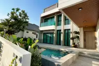 5 Bedroom House for Sale at Impress House Village private pool with tropical garden landscaping and wooden-ceiling entrance