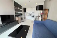 1 Bedroom Condo for Sale at The Vision living area with city view from floor-to-ceiling windows and dining table.