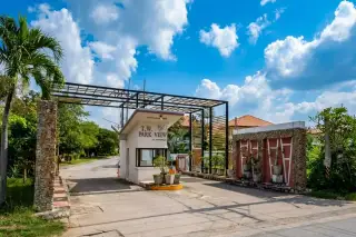 T.W. Park View main entrance gate with a security guardhouse and property signage under a metal archway.