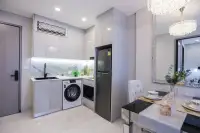 1 Bedroom Condo for Sale at Copacabana Coral Reef modern kitchen with grey cabinets, marble backsplash, washing machine, and dining table