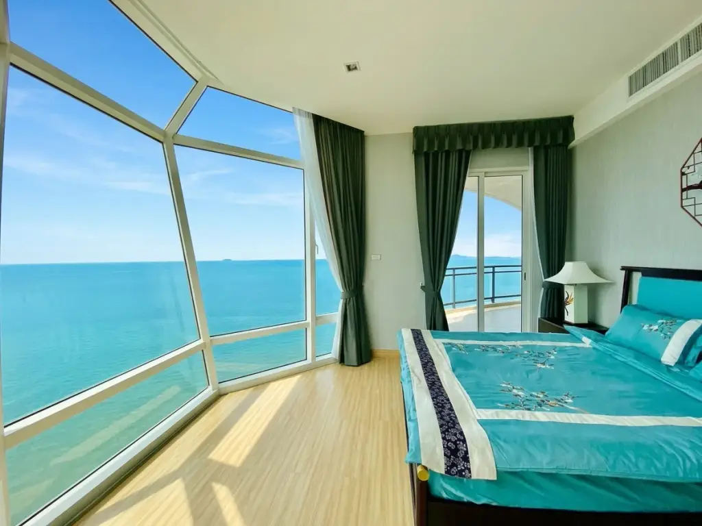 3 Bedroom Condo for Sale at Reflection Jomtien Beach bedroom with panoramic floor-to-ceiling ocean view windows