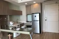 1 Bedroom Condo for Sale at Cetus Beachfront kitchen and dining area with glass table, stainless fridge and smart door lock