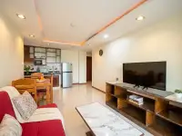 1 Bedroom Condo for Sale at Hyde Park Residence 2 living area with red sofa, flat-screen TV, and wooden shelving