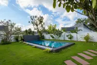 3 Bedroom House for Sale at Coco Ville 2 Pong - Bang Lamung private pool with stone waterfall feature and manicured lawn garden