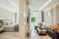 1 Bedroom Condo for Sale at The Coral Pattaya view from hallway showing kitchen, dining area, living room, and bedroom.