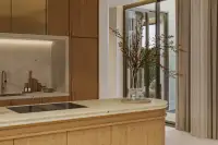 4 Bedroom House for Sale at Solava Pattaya close-up of kitchen island with induction hob, stone countertop, and lit backsplash niche