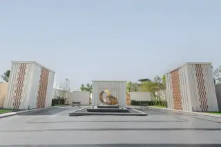 Cascade contemporary house exterior with three cars parked in the driveway and lush green landscaping.