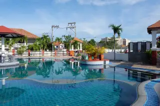 Pattaya Lagoon Village private swimming pool with blue tiles and an outdoor dining area under a covered patio.